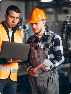 Engineers analyzing structural data on laptop for building inspection and engineering assessment services